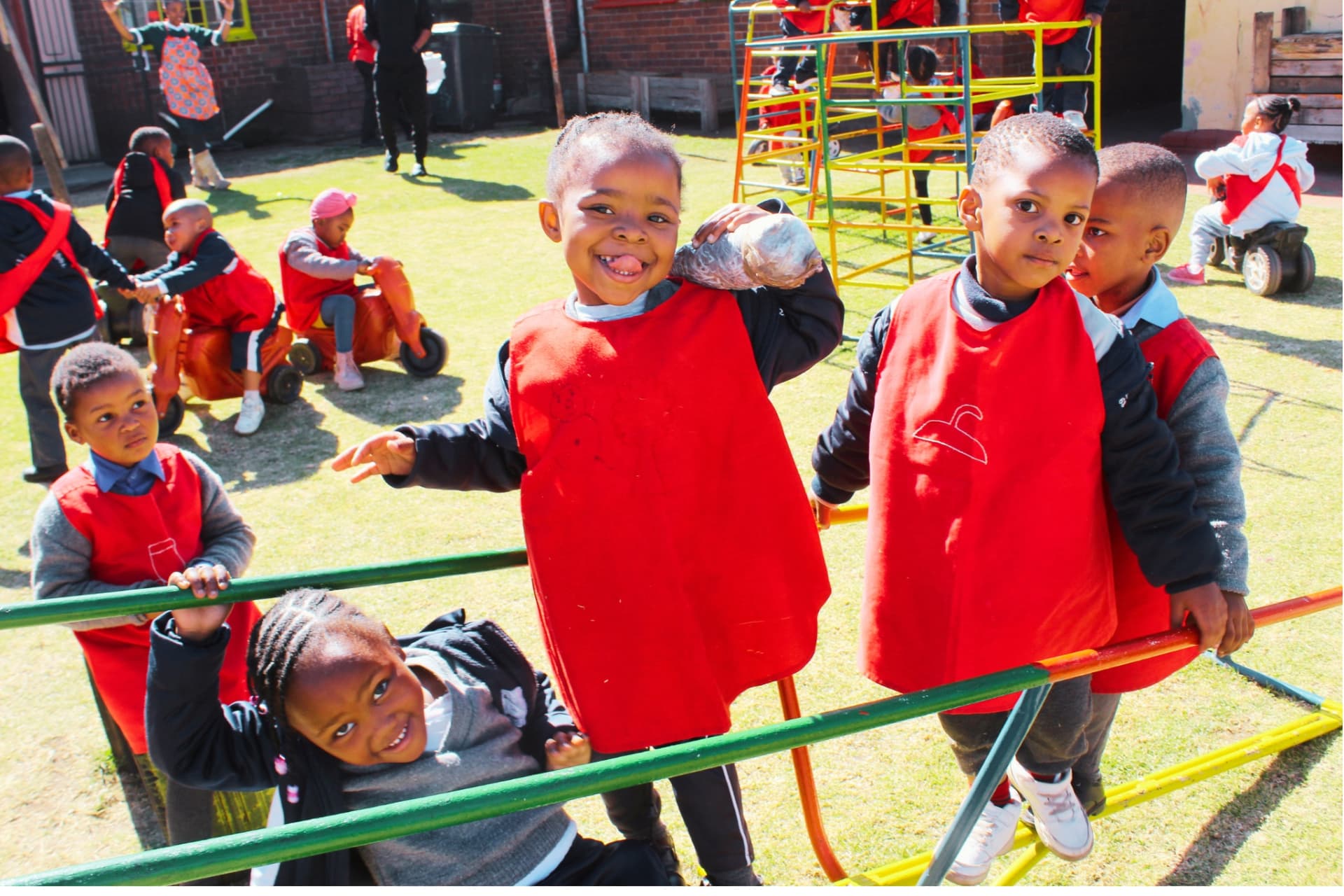 Children laughing on the jungle gym during outdoor play at Matla Pre School
