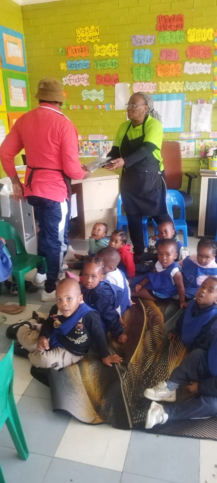 Teachers guiding toddlers during a busy classroom morning routine