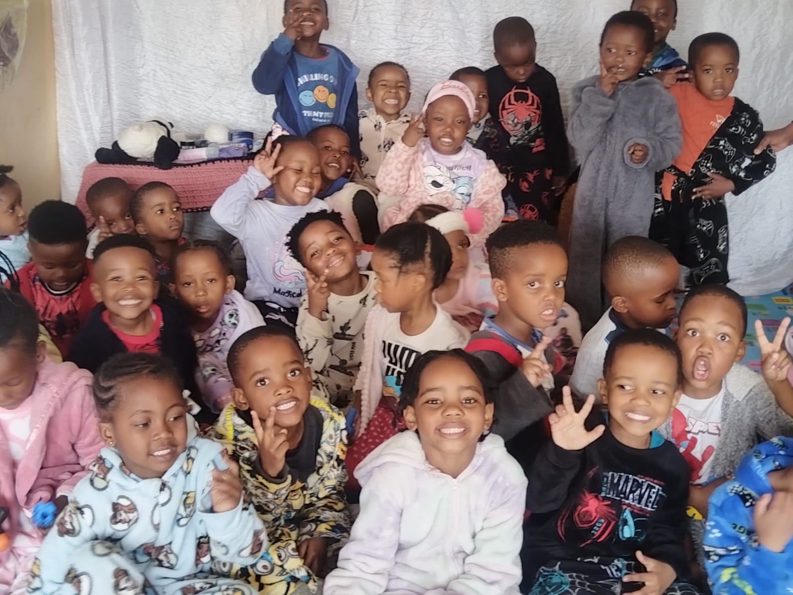 Matla learners in colourful pyjamas posing together for Pajama Day