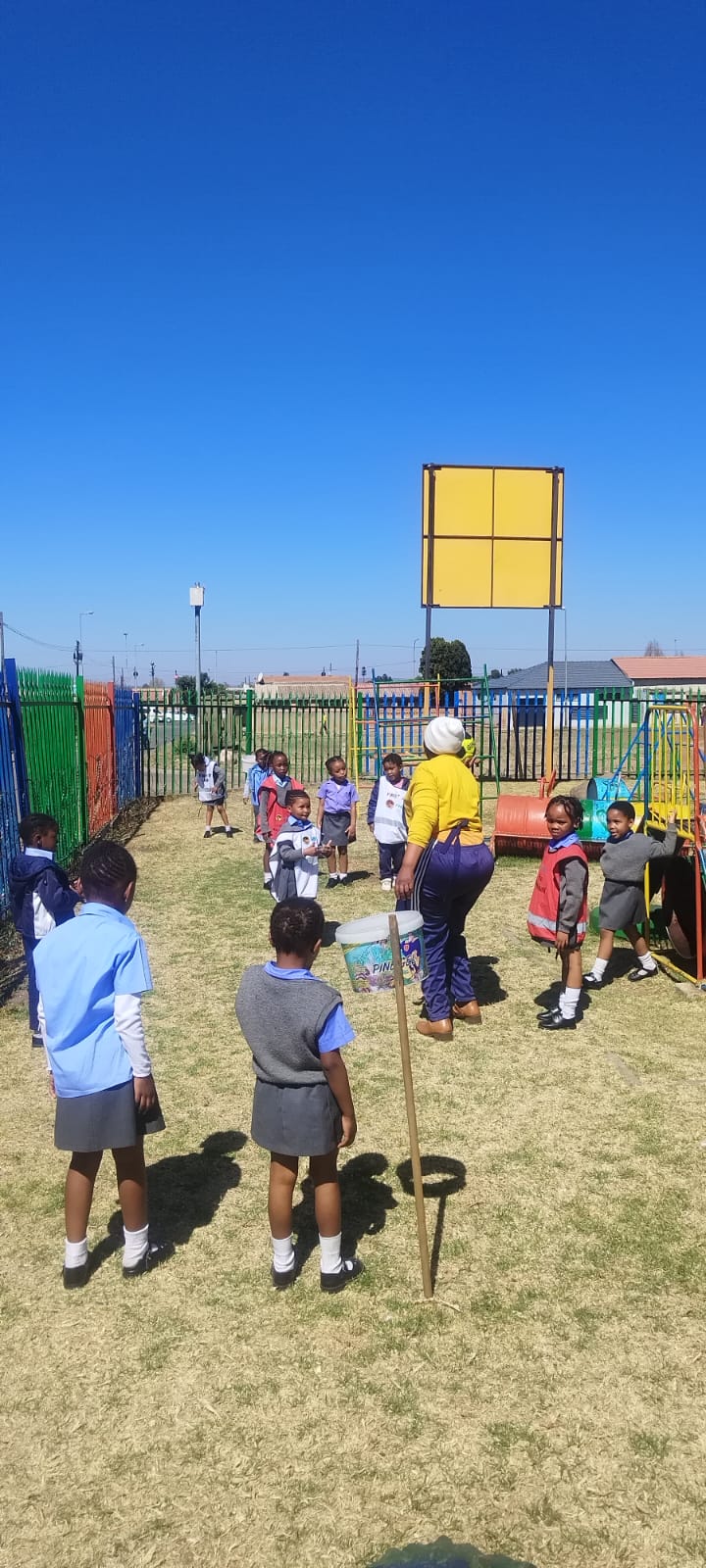 A teacher reading a picture book to a circle of engaged learners