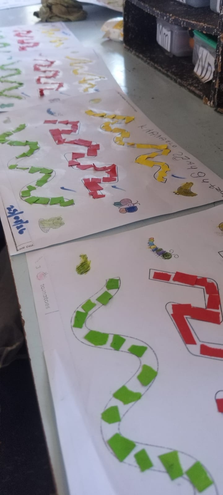 Learners creating colourful paper-and-paste art at their desks